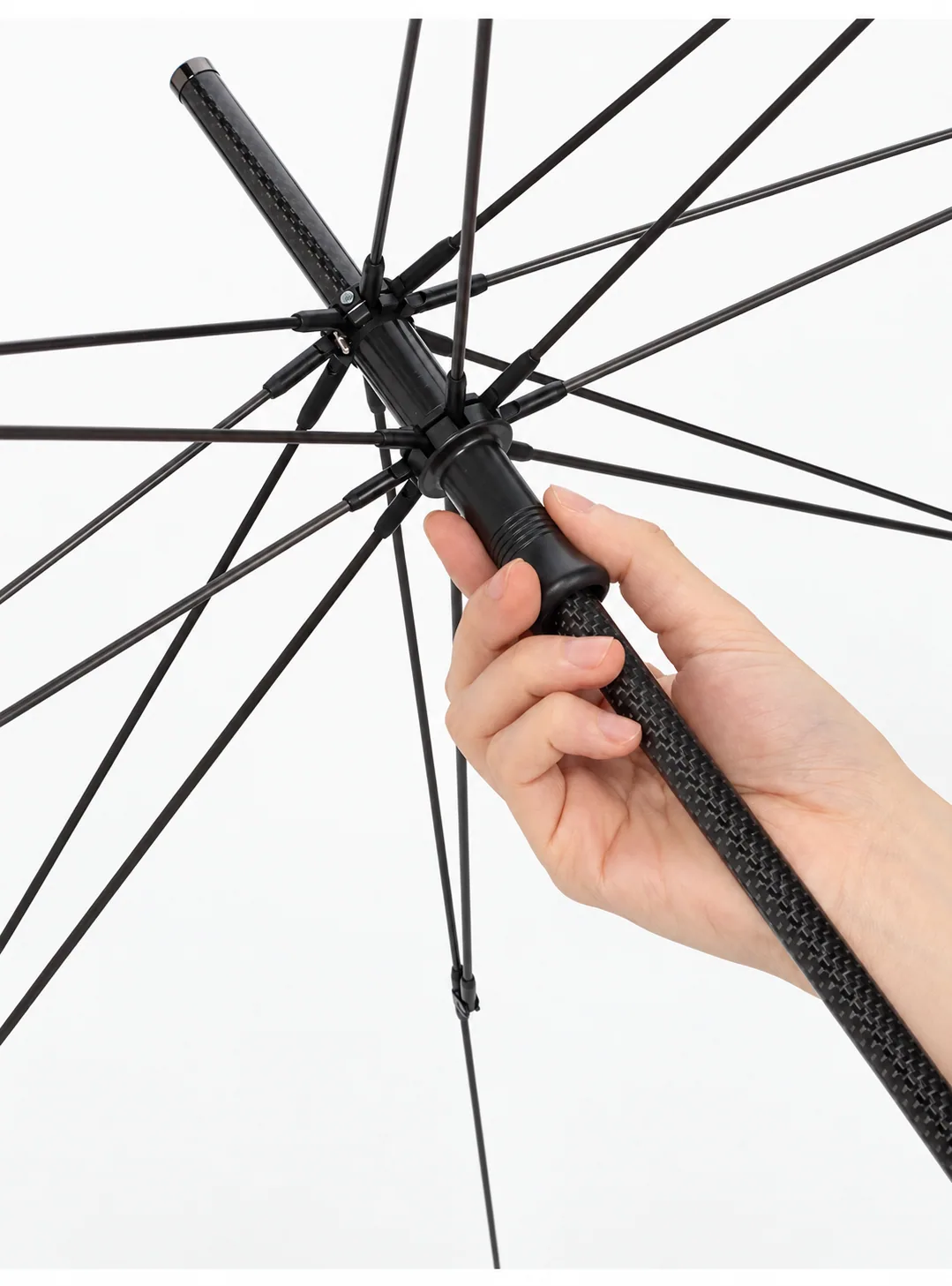 Hand sliding the runner of the carbon-fibre umbrella