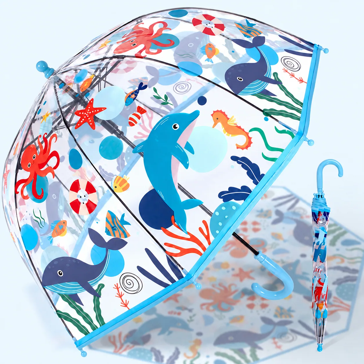 Open and closed clear umbrellas printed with dolphins, whales and sea creatures